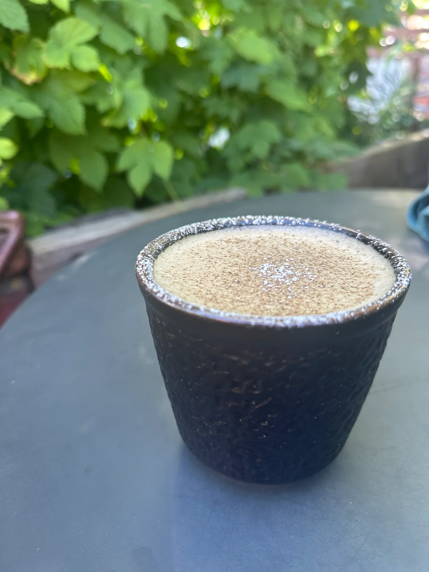 A chai latte made with A2 milk in a textured ceramic cup at Zi Spice in Ashland, Oregon