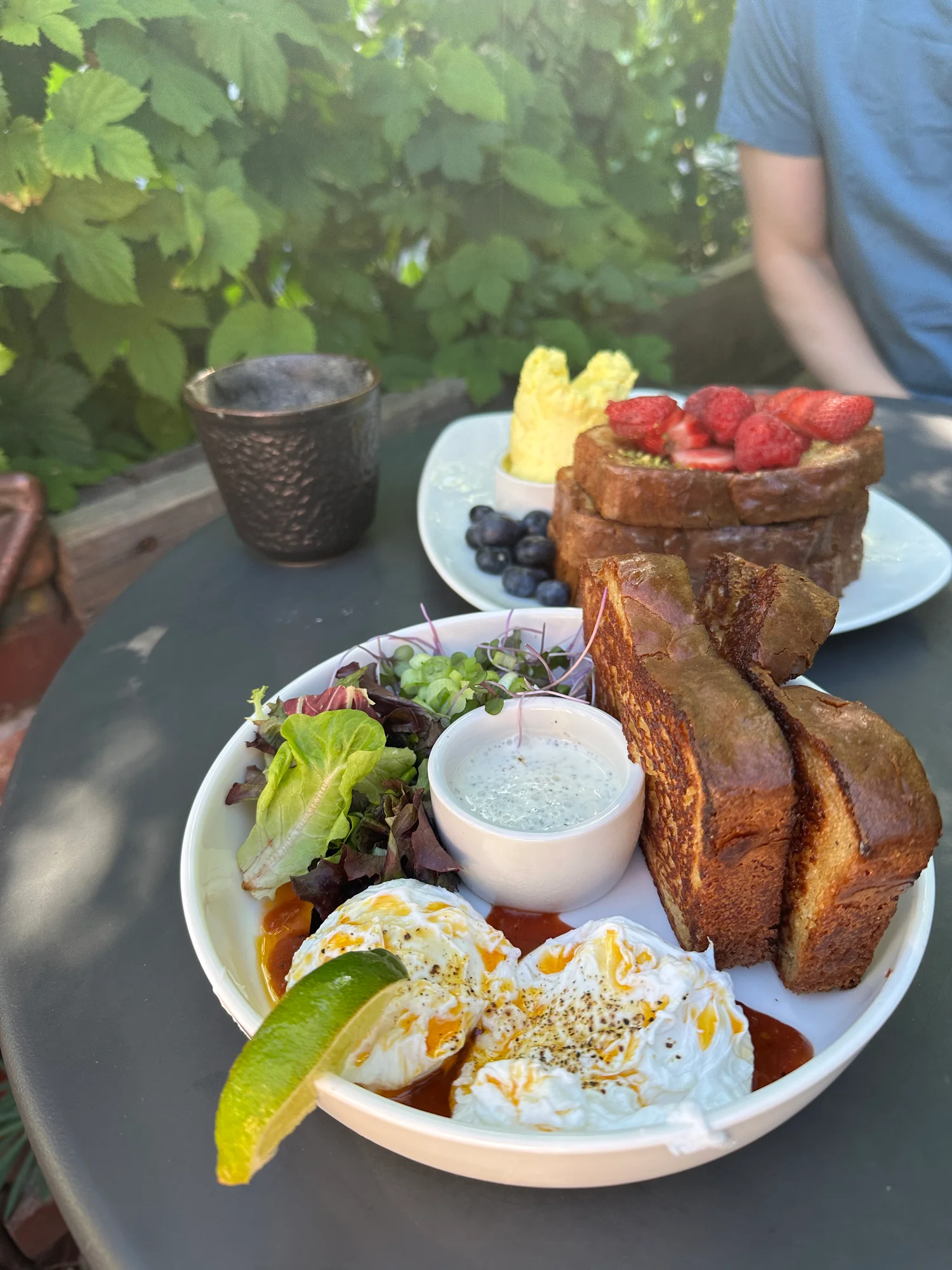 Brunch spread at Zi Spice in Ashland, Oregon: poached eggs with gluten-free sourdough and strawberry-topped French toast