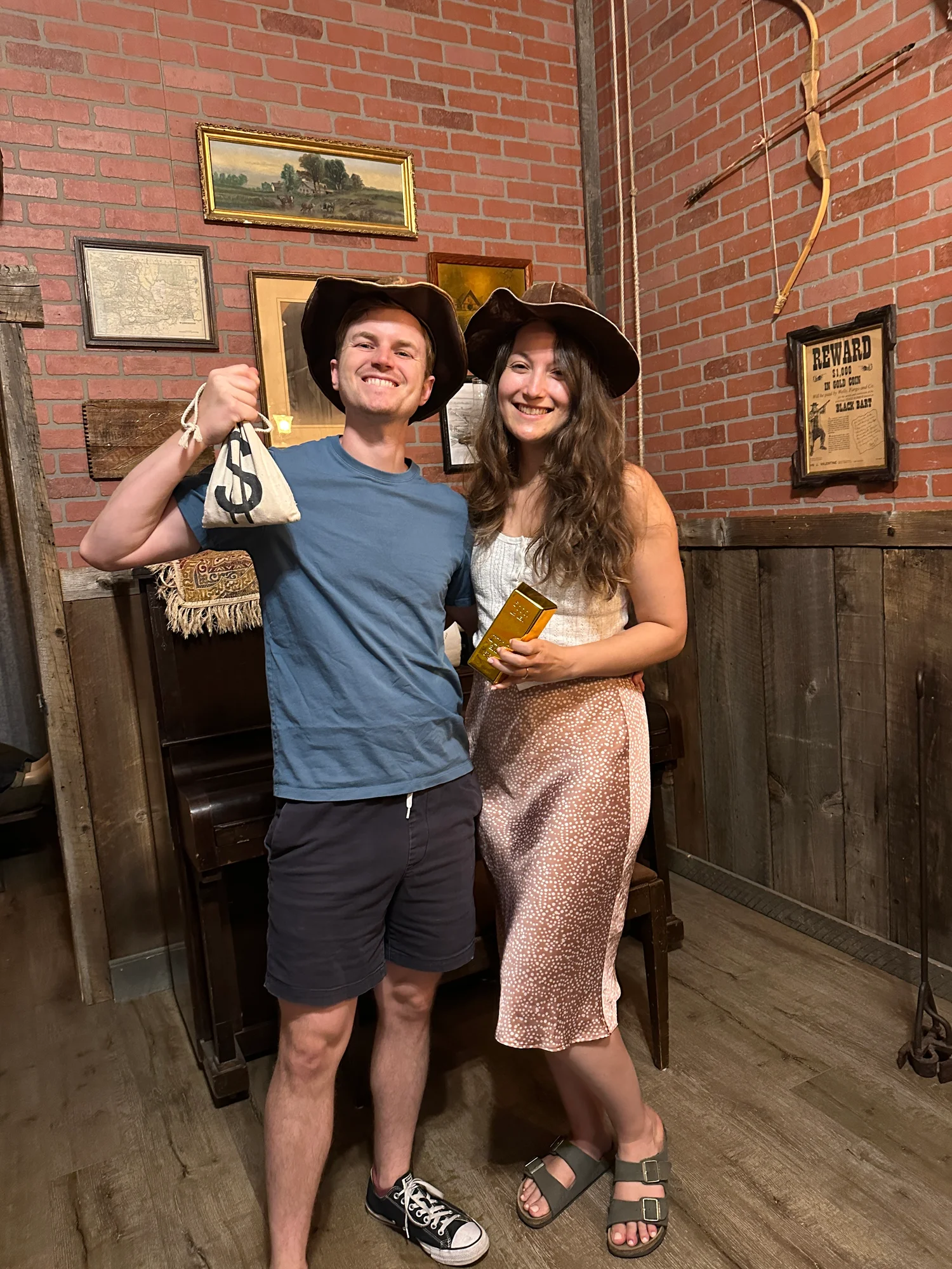 Celebrating a Wild West escape room win in cowboy hats in Ashland, Oregon