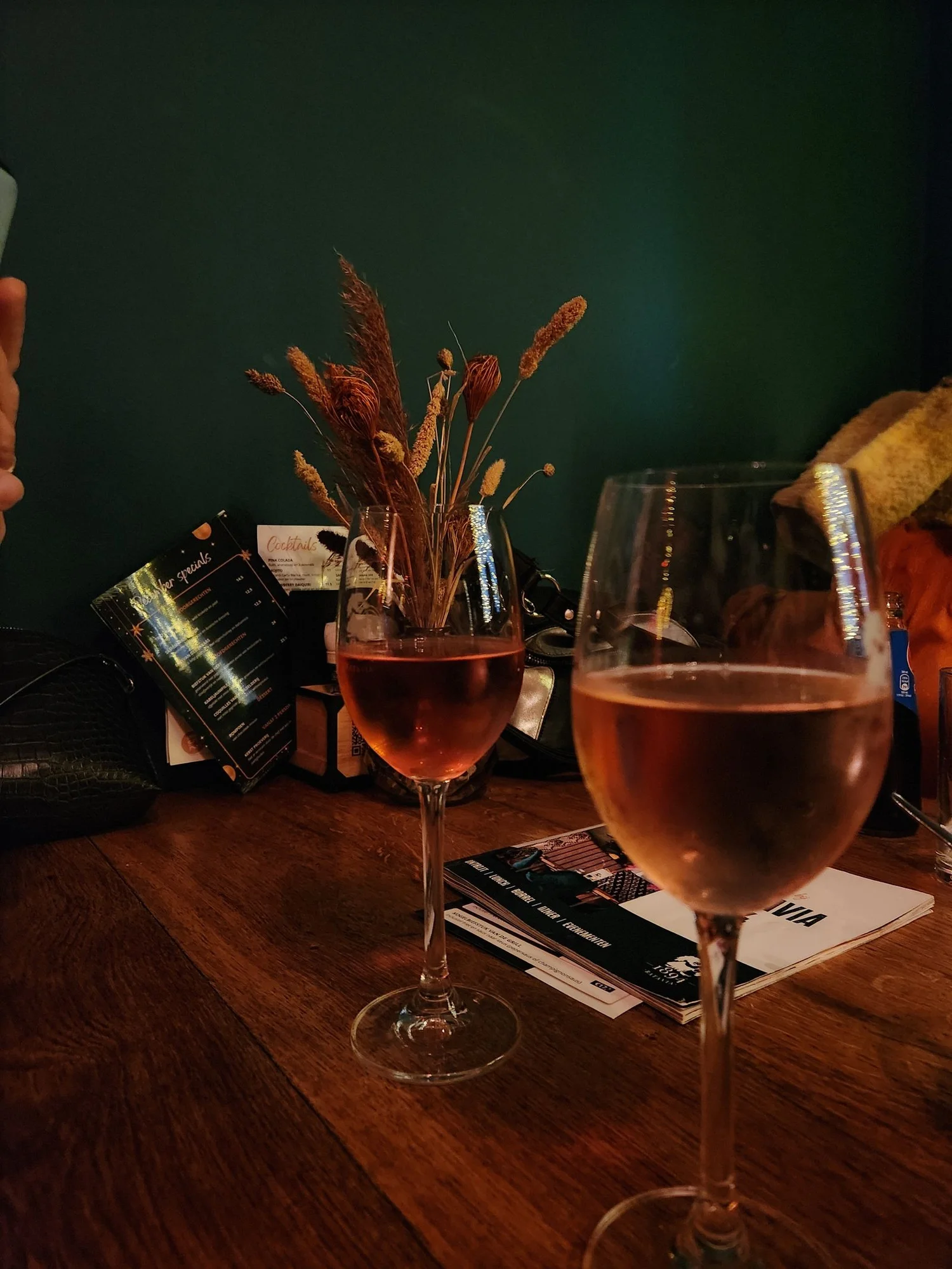Two glasses of wine on a wooden table like an evening at Bodega Wine Bar in Santa Monica