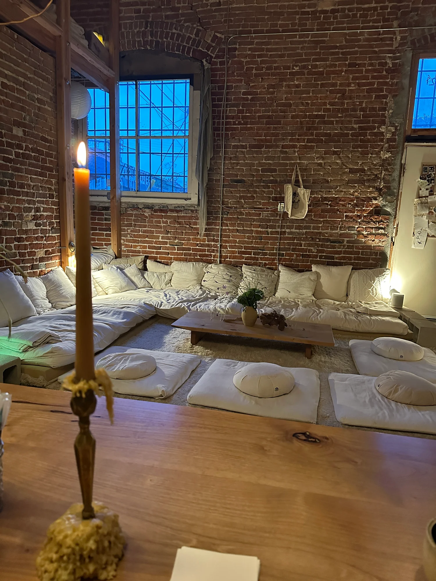 Floor cushions and candlelight inside Shiloh Tea House in DTLA