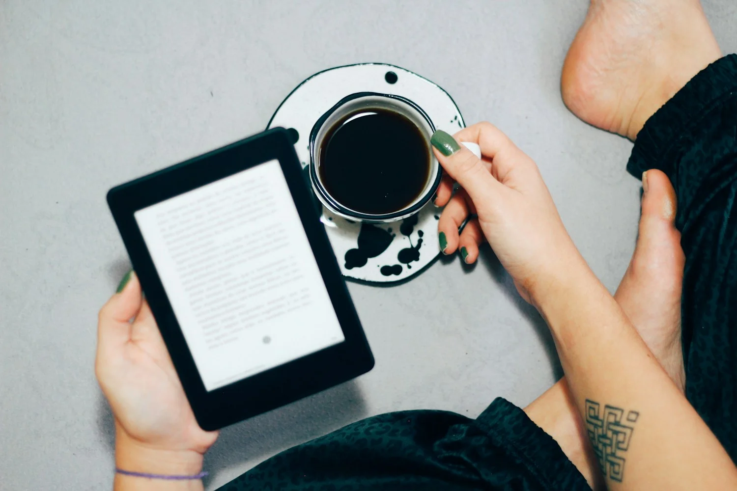 A stack of advance reader copies and a phone, the NetGalley reader setup