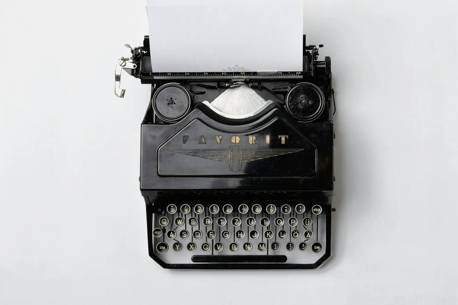 A vintage typewriter with a fresh page loaded, ready for the next installment