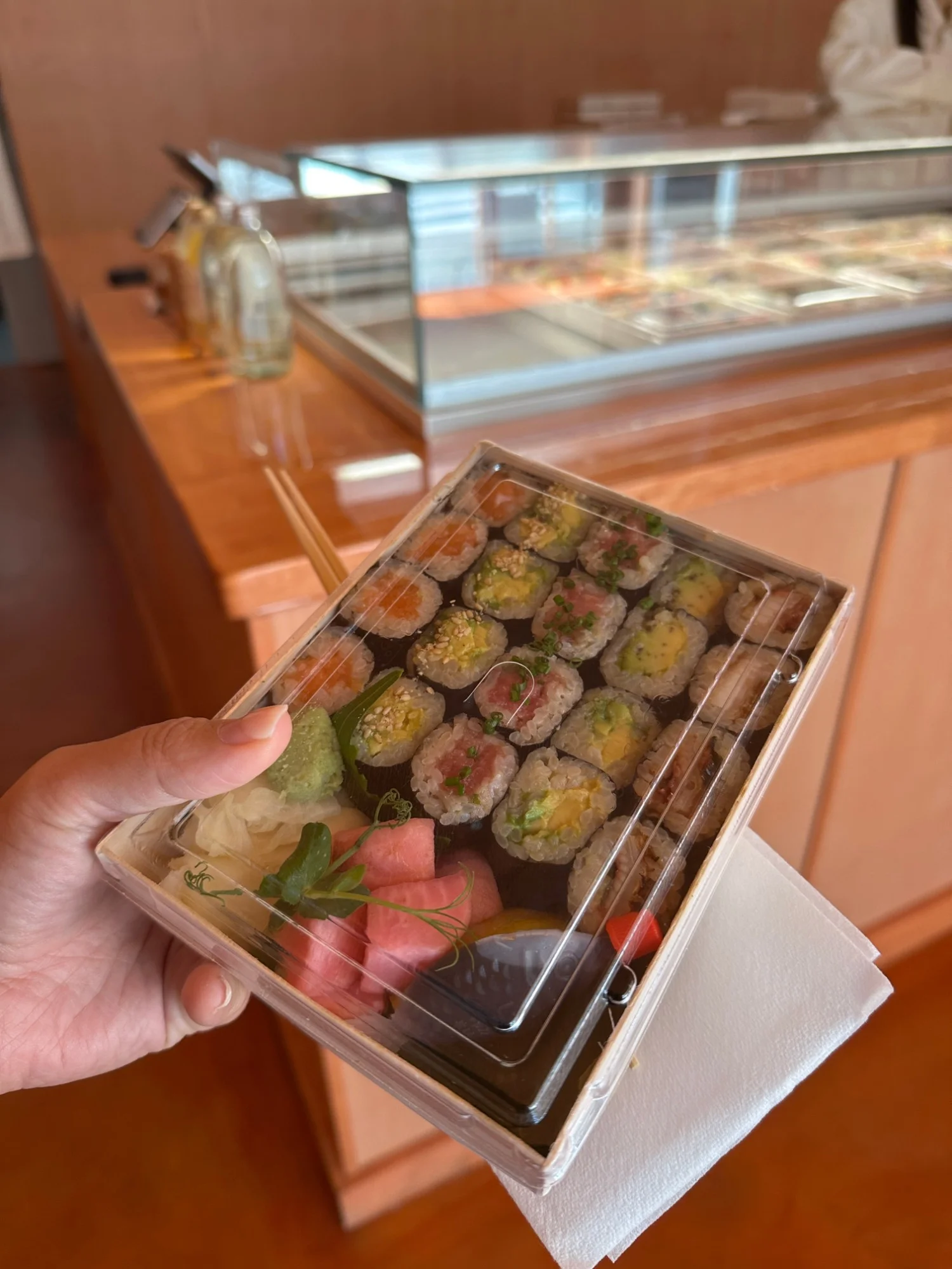 The Hosomaki box from Aji Kiji in San Francisco's Financial District, thin sushi rolls in a wooden takeout box with watermelon and pickled ginger