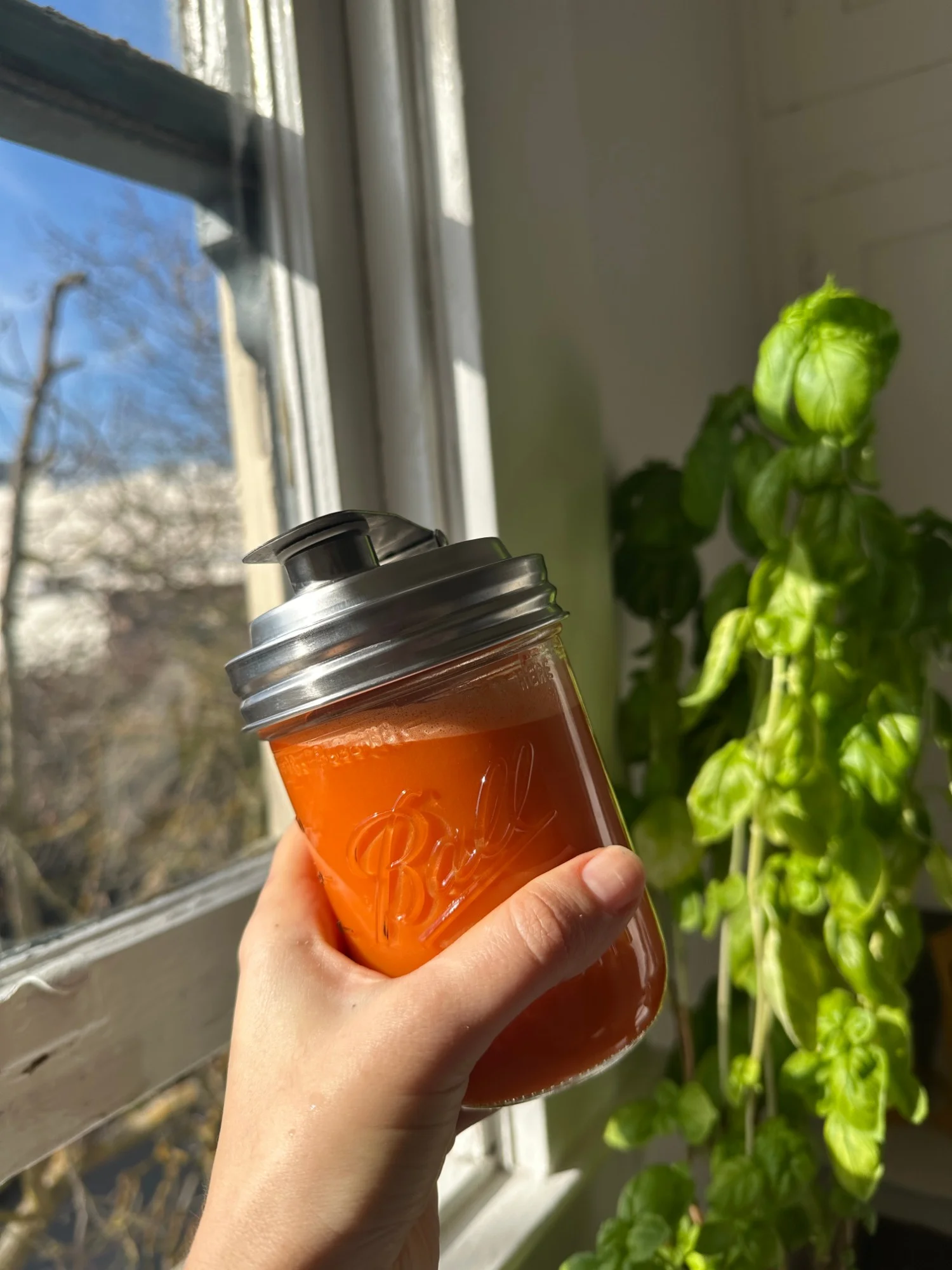 A jar of fresh cold-pressed carrot juice made from Clement Street Farmers Market produce
