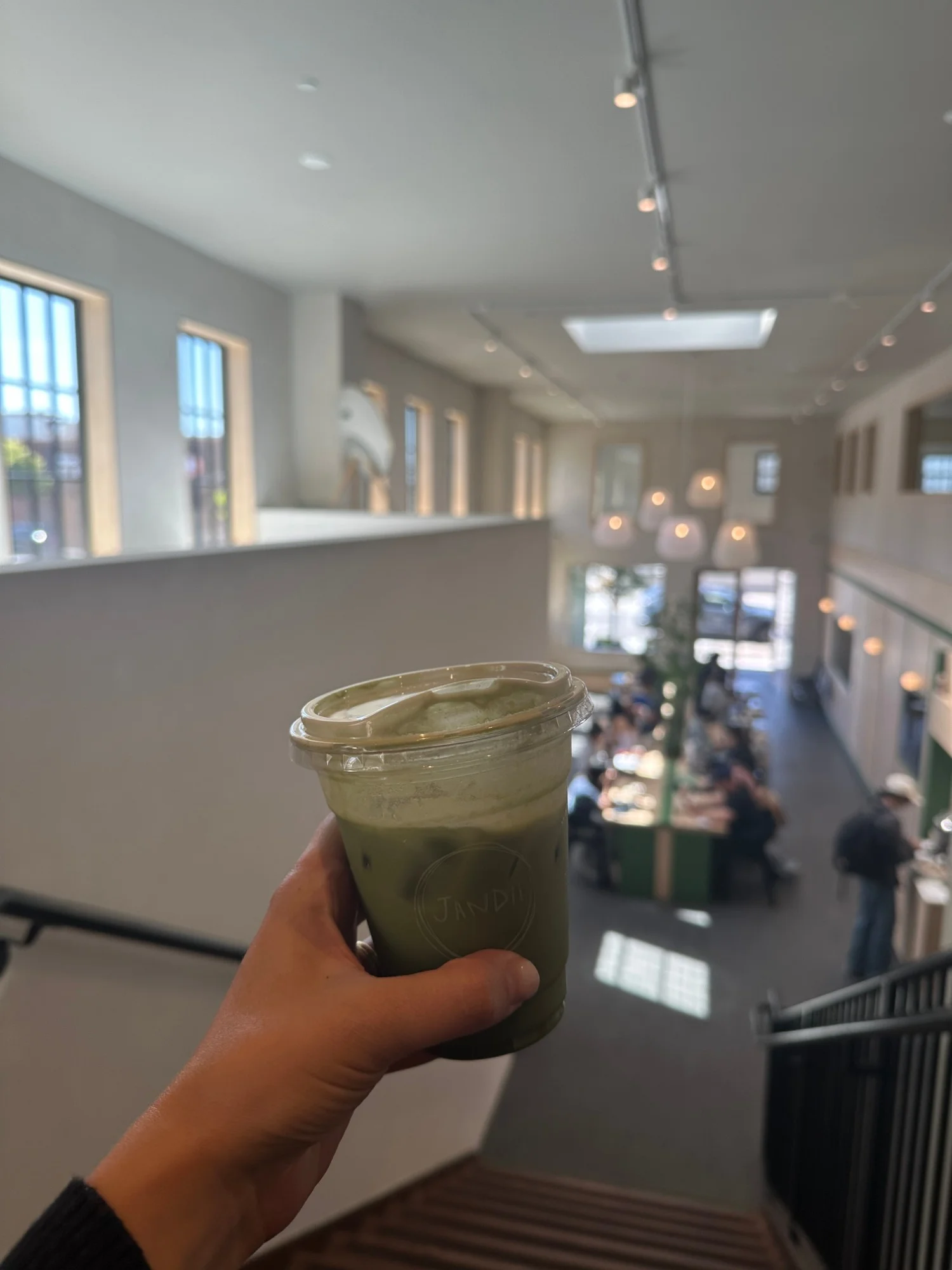 The high-ceilinged light-filled interior of Jandii Cafe on Taraval Street seen from the upstairs seating