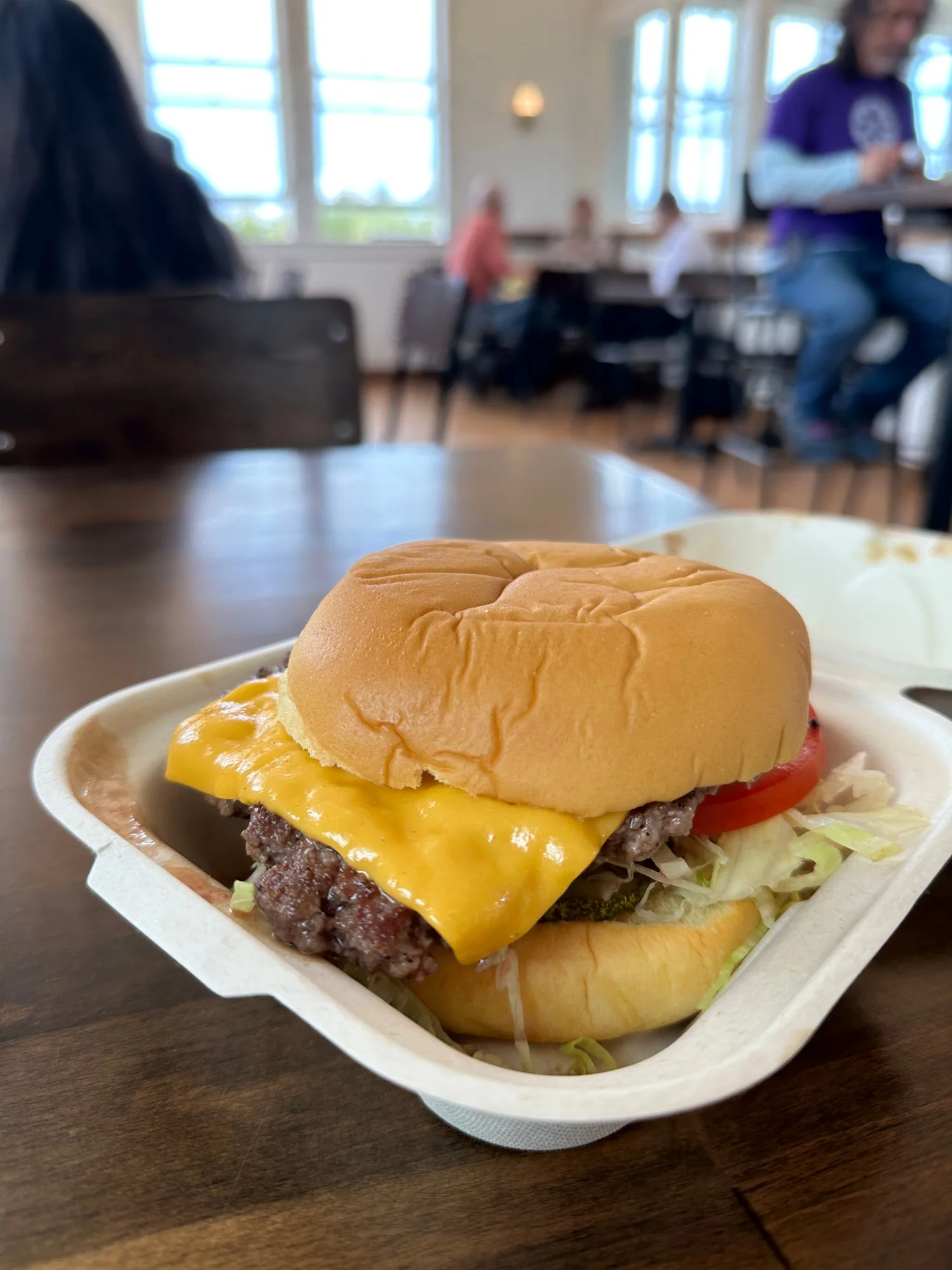 Breadwinner's smash burger at the Mess Hall at the Presidio, American cheese, shredded lettuce, tomato and pickles in a compostable tray