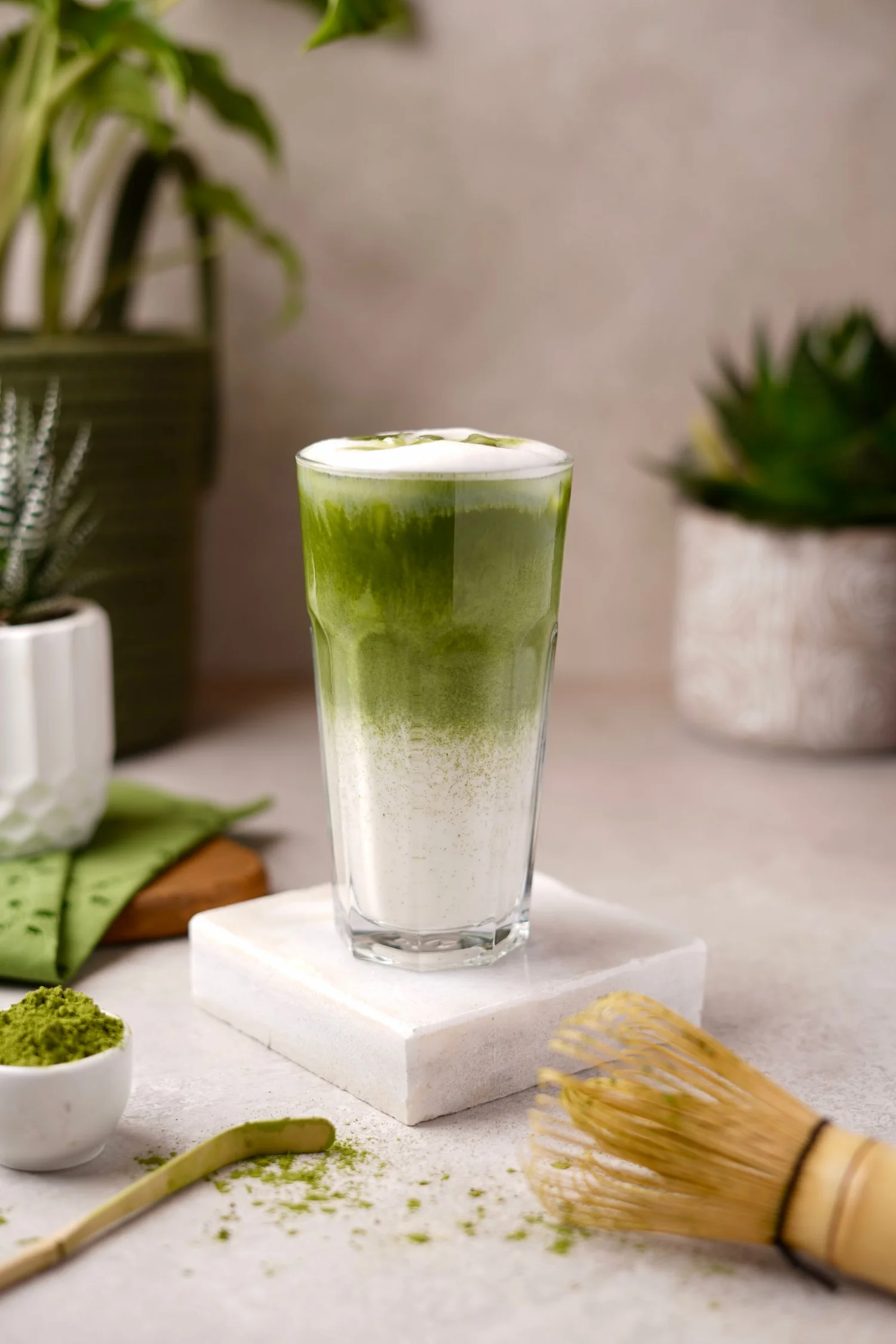 An iced matcha drink with a whisk, like the treat-tier matcha at Q Specialty Coffee in San Francisco
