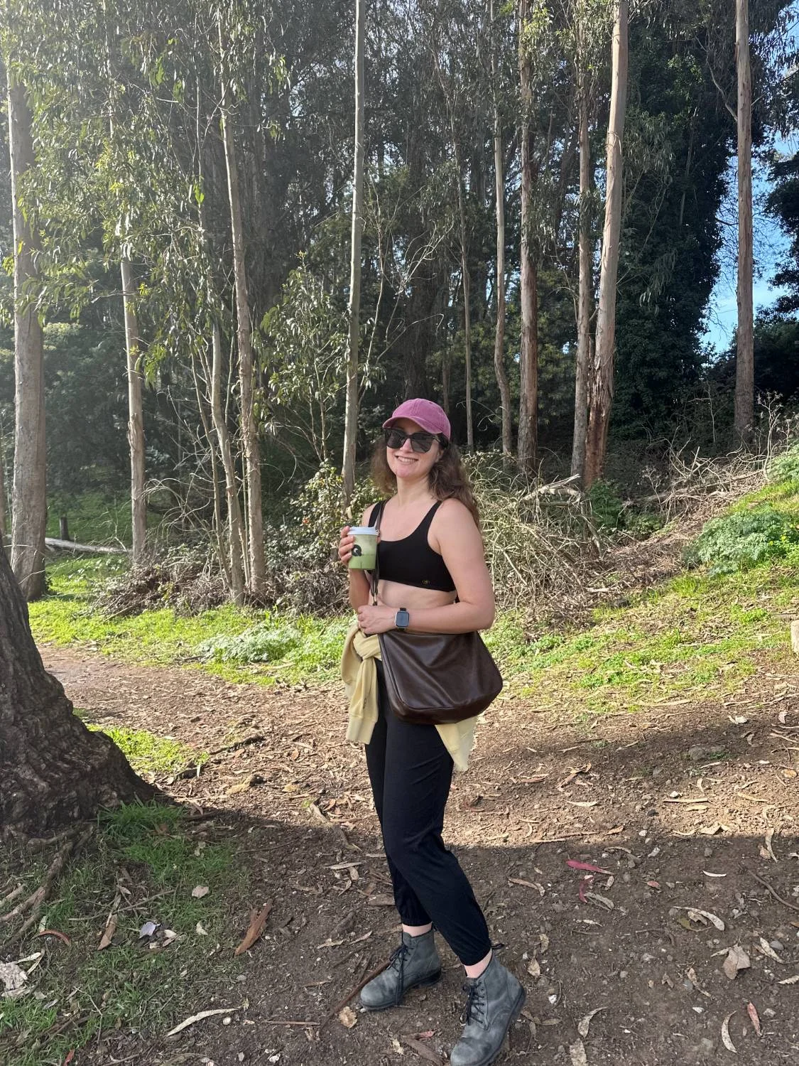 Amy on a eucalyptus-lined San Francisco trail holding a matcha