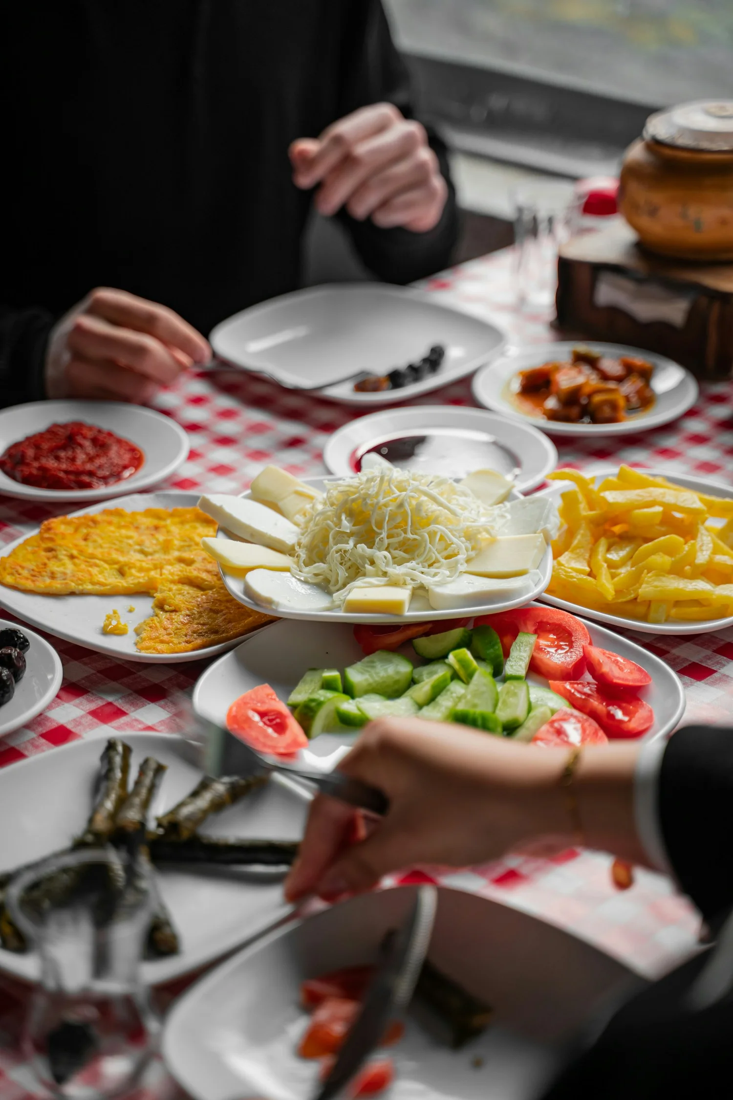 A shared Turkish breakfast table of cheeses, olives, and spreads like the weekend spread at Troya in San Francisco