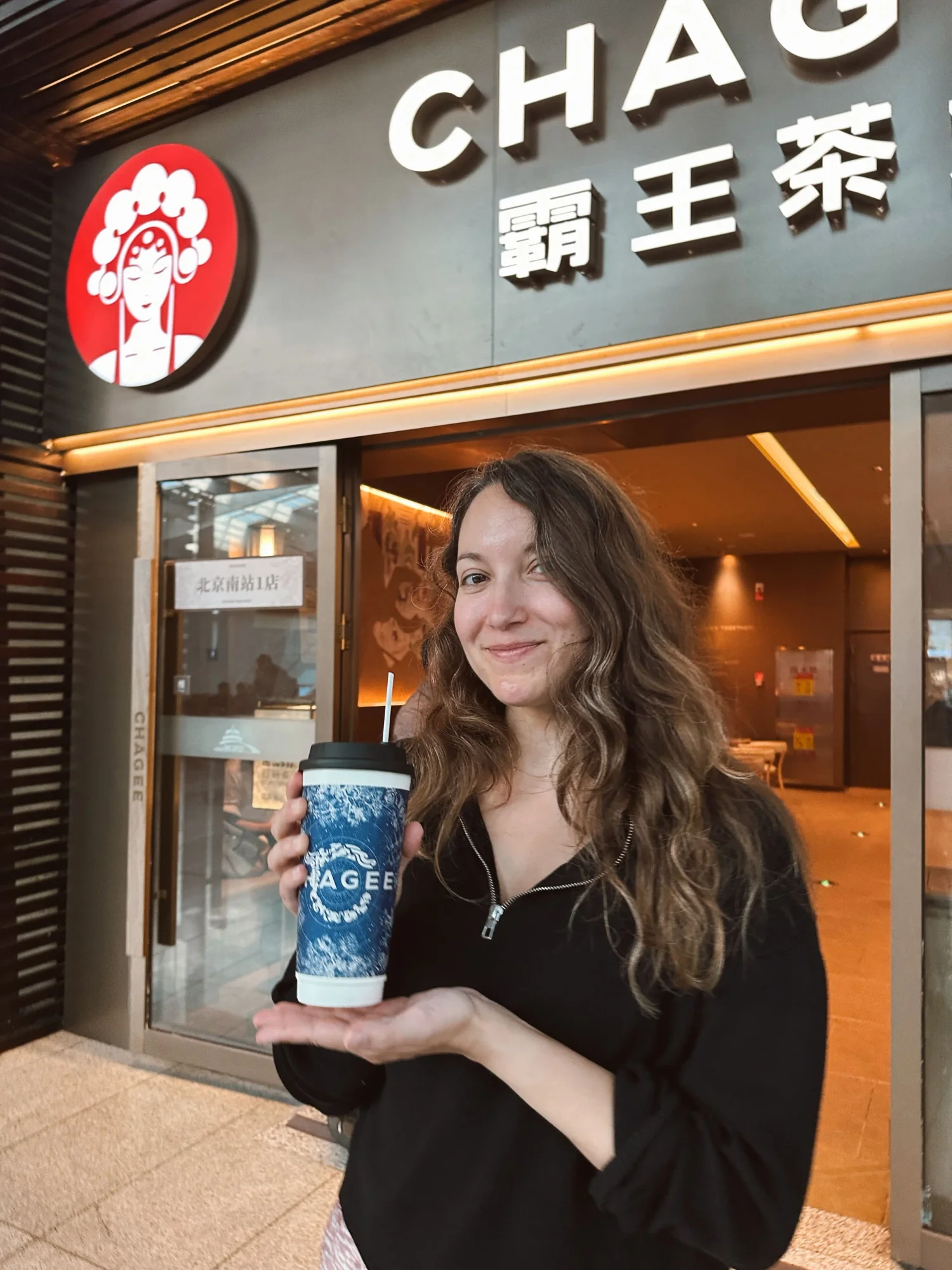 Freelance writer Amy Suto enjoying Chagee tea in Beijing, China before a Great Wall of China tour. Perfect stop for travelers exploring modern tea culture in China while planning their Great Wall of China trip or Beijing itinerary.