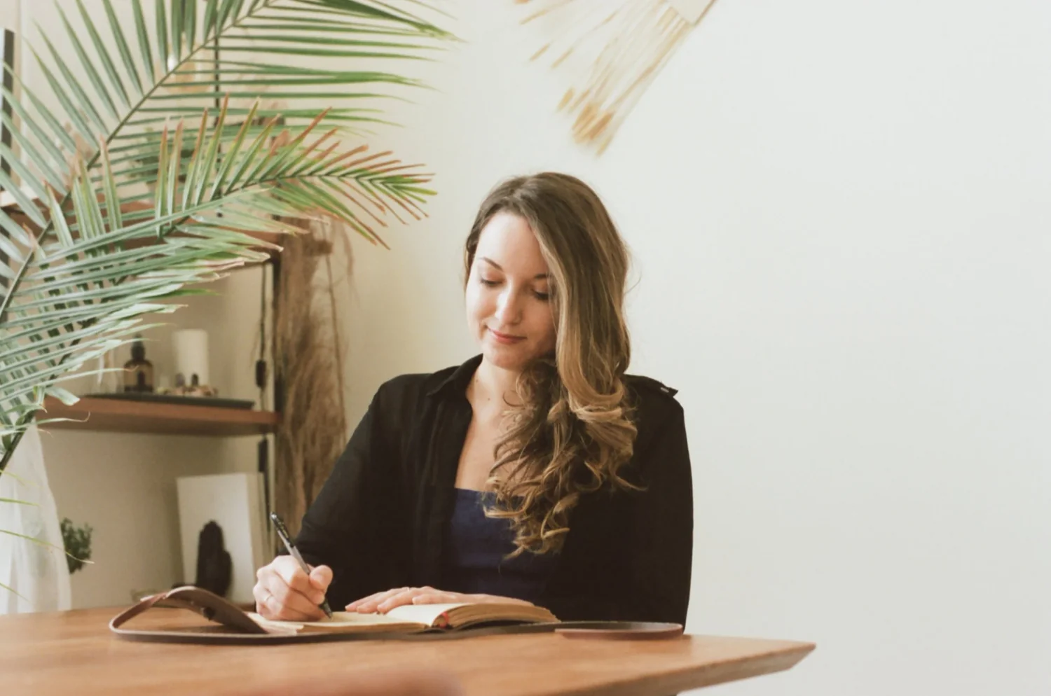 Amy Suto writing in a journal, illustrating the reflective and personal nature of memoir ghostwriting, as discussed in the post ‘What is a Memoir Ghostwriter and What Do They Do?