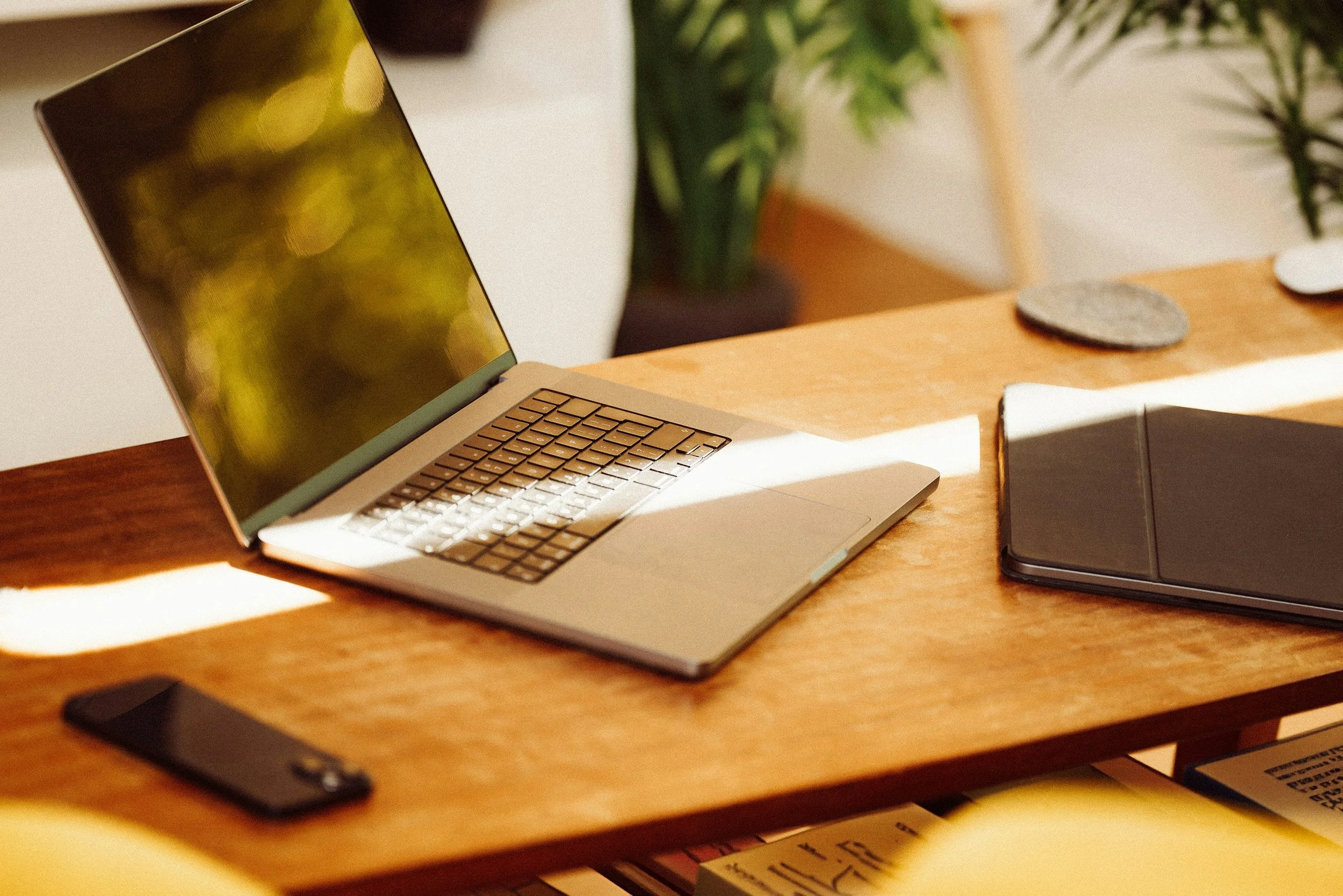 Modern workspace setup with laptop and notebook, representing professional ghostwriting services for authors, founders, and brands seeking a skilled ghostwriter for hire.