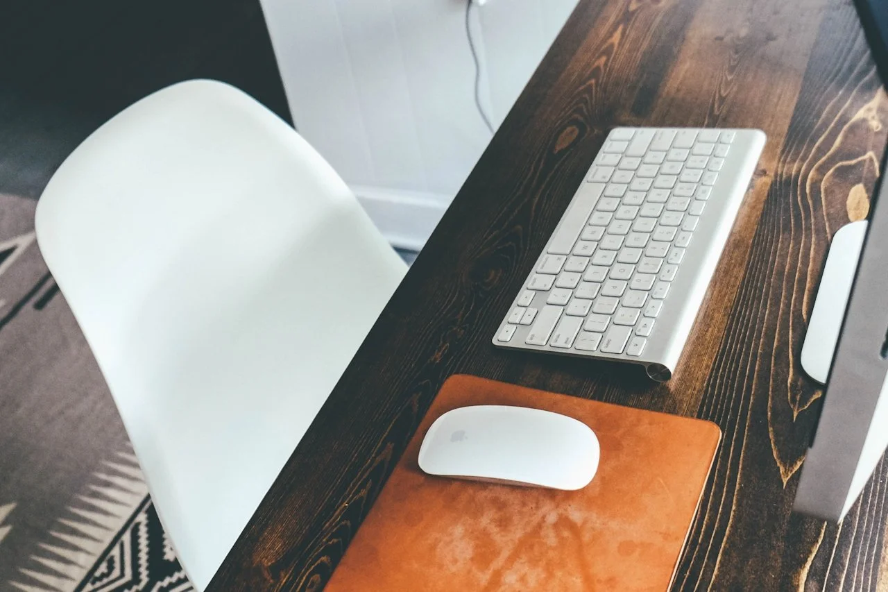 Minimalist freelance writing desk setup with keyboard, mouse, and computer, representing remote work for Upwork freelance writing, Upwork alternatives, and websites similar to Fiverr.