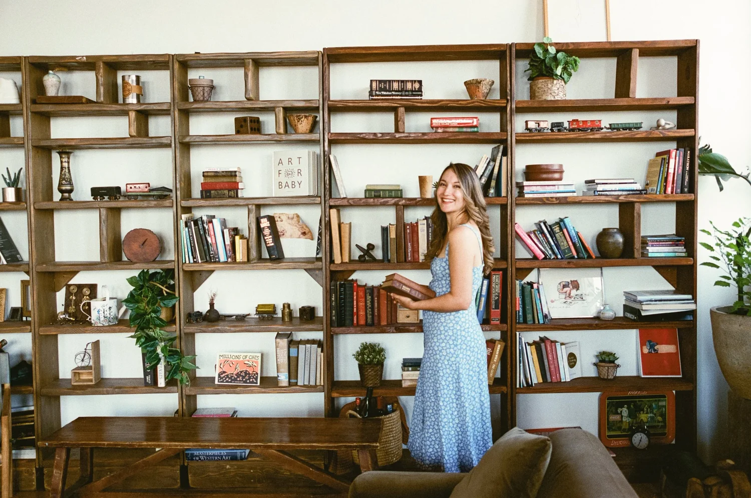 Photo of Amy Suto standing in front of bookshelves, how to self-publish your book on Amazon