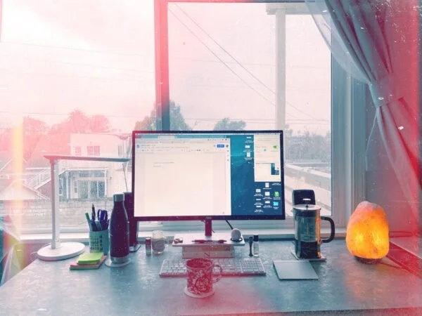 my desk, where I can watch birds do dive bombs and scare squirrels off of the power lines
