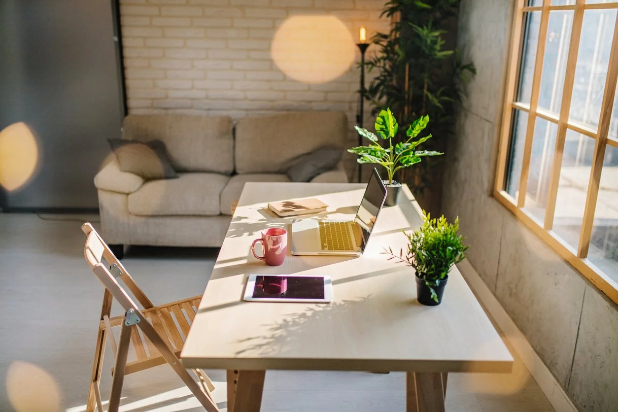 Bright, modern writing workspace with a laptop and coffee mug — the kind of setup freelance proofreaders and editors use for delivering high-quality book proofreading and manuscript editing services remotely.