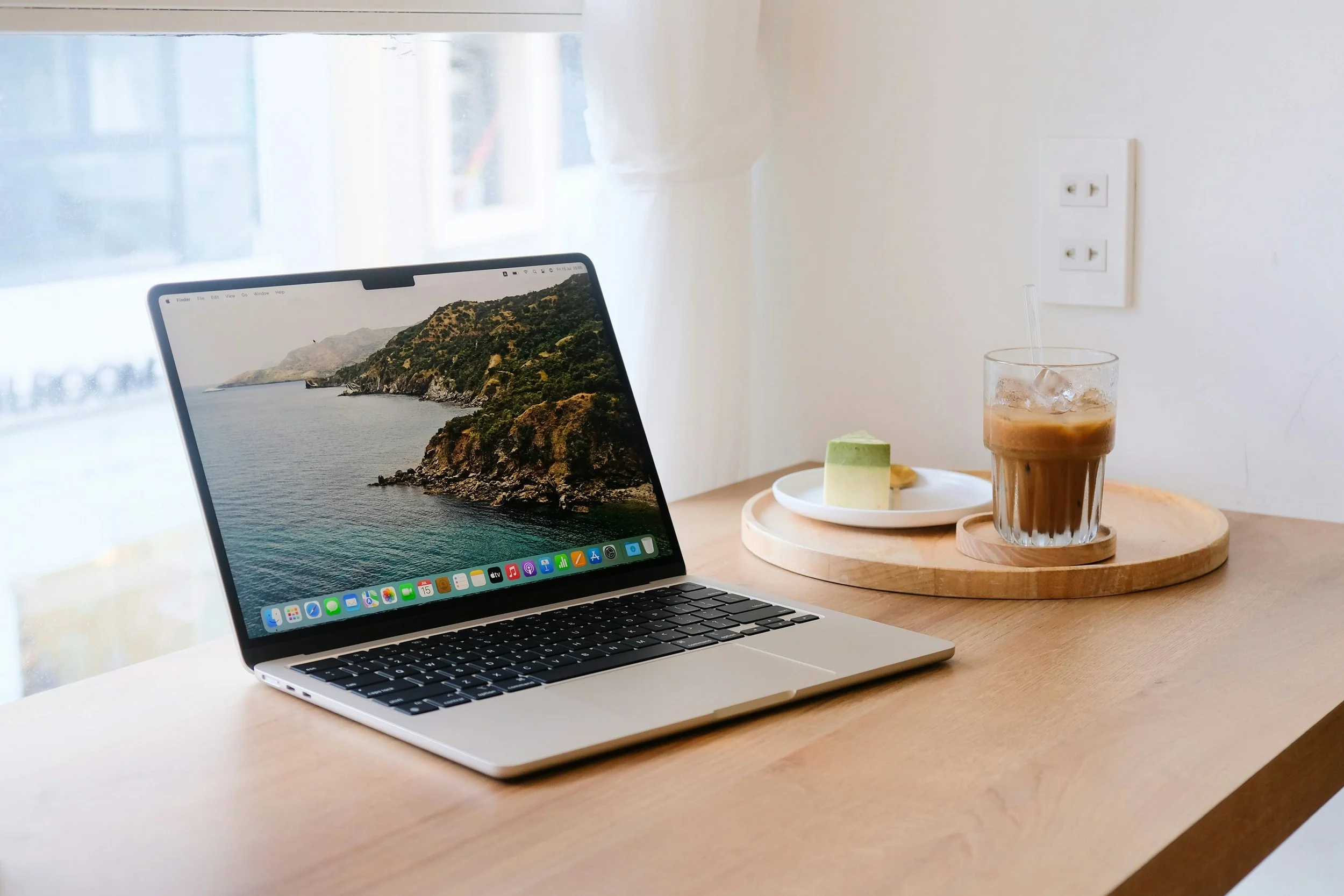 Remote work setup with laptop and iced coffee — perfect for remote writing jobs and work-from-home writing gigs.